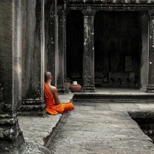 A monk meditates at the Angkor Wat temple in Siem Reap Cambodia.