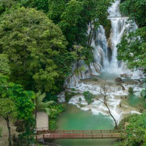 Aerial view Tat Kuang Si Waterfall in Luang Prabang, Laos, Beautiful waterfall in jungle tropical rainforest and wooden bridge at Tat Kuang Si, Luang Prabang, Laos.