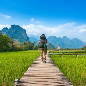 Tourism with backpack walking on wooden path, Vang vieng in Laos.